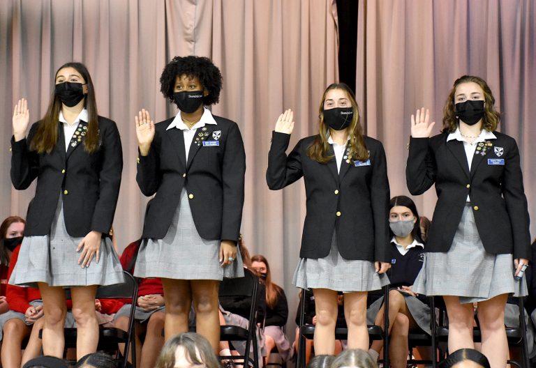 E-Board officers raise their right hand to be inducted during the Student Council and Club Officer Induction