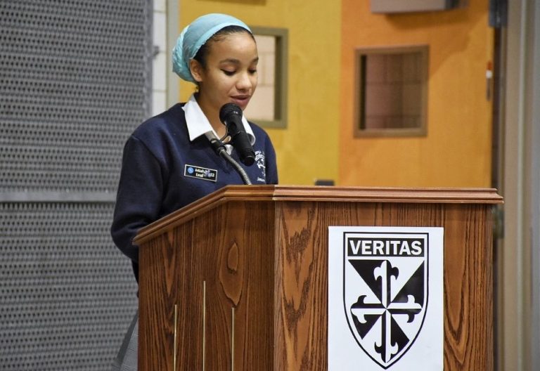 Student reads her reflection at Mass of Immaculate Conception.