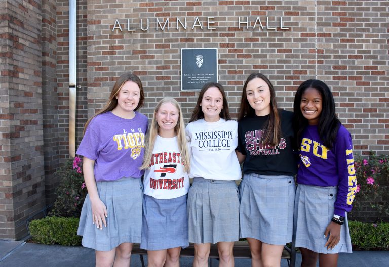 Five Dominican athletes pose for a photo before signing day